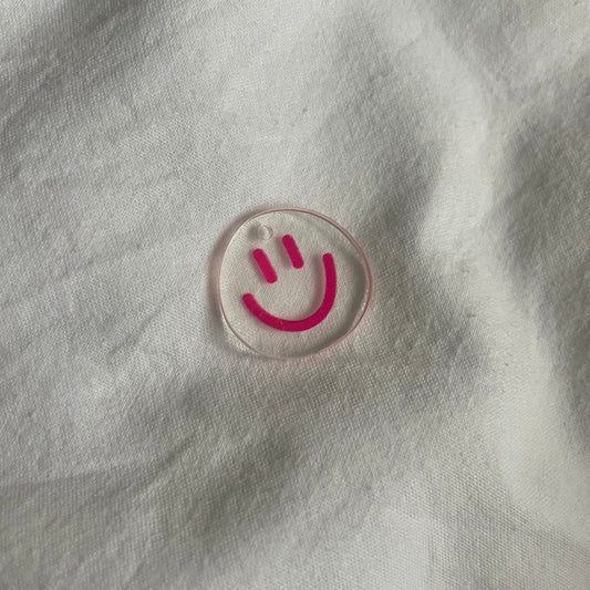 Charm: transparante roze smiley